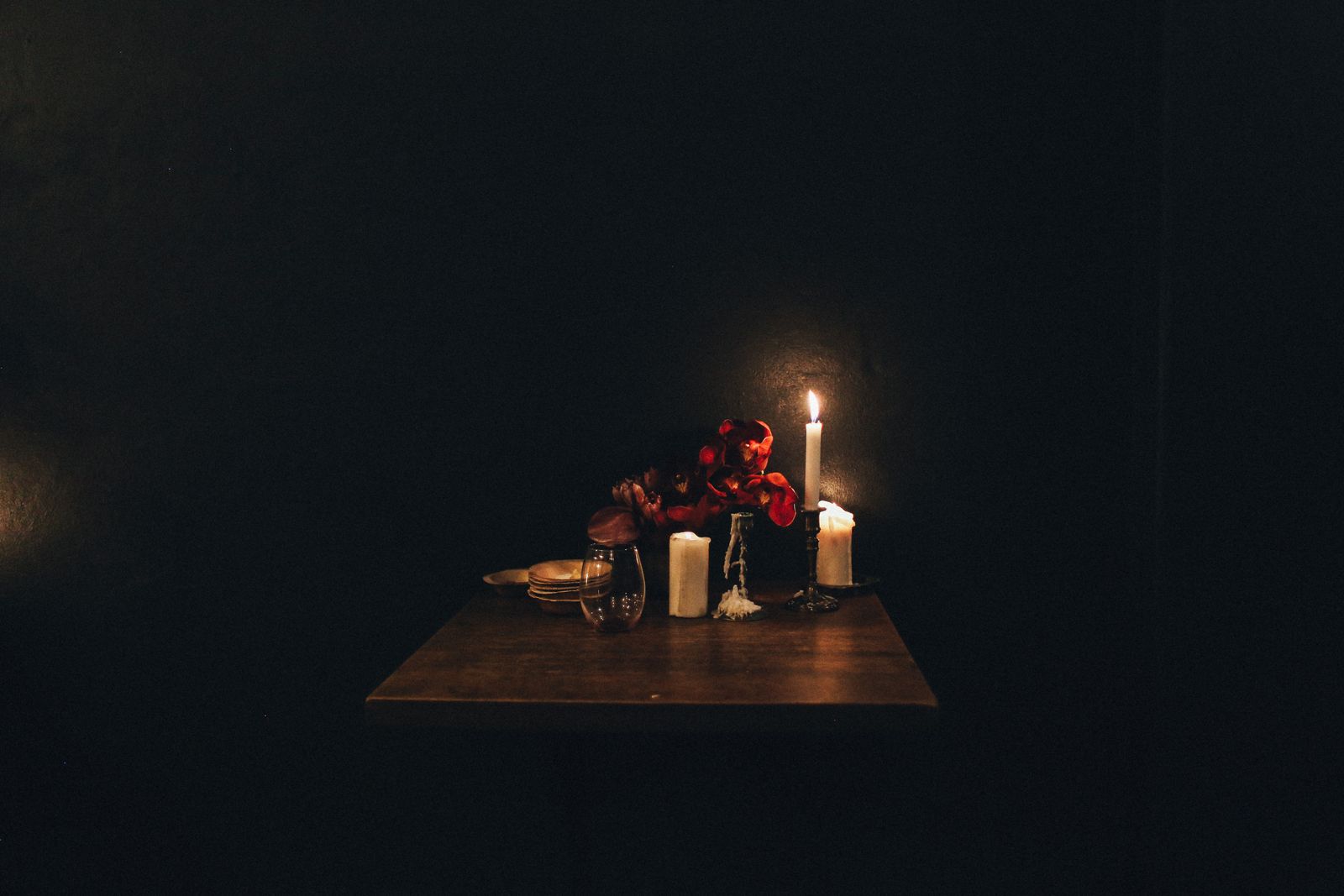 A candlelit private table set with roses in the Vine Room