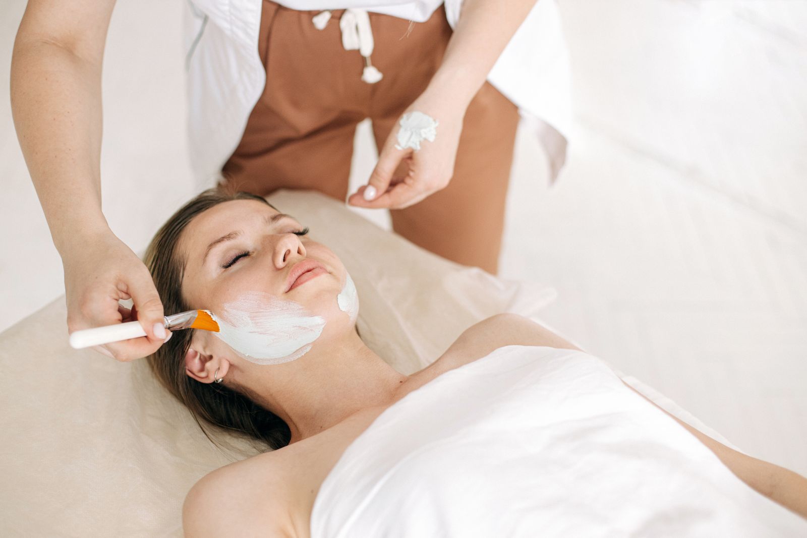 A client resting during a facial mask application