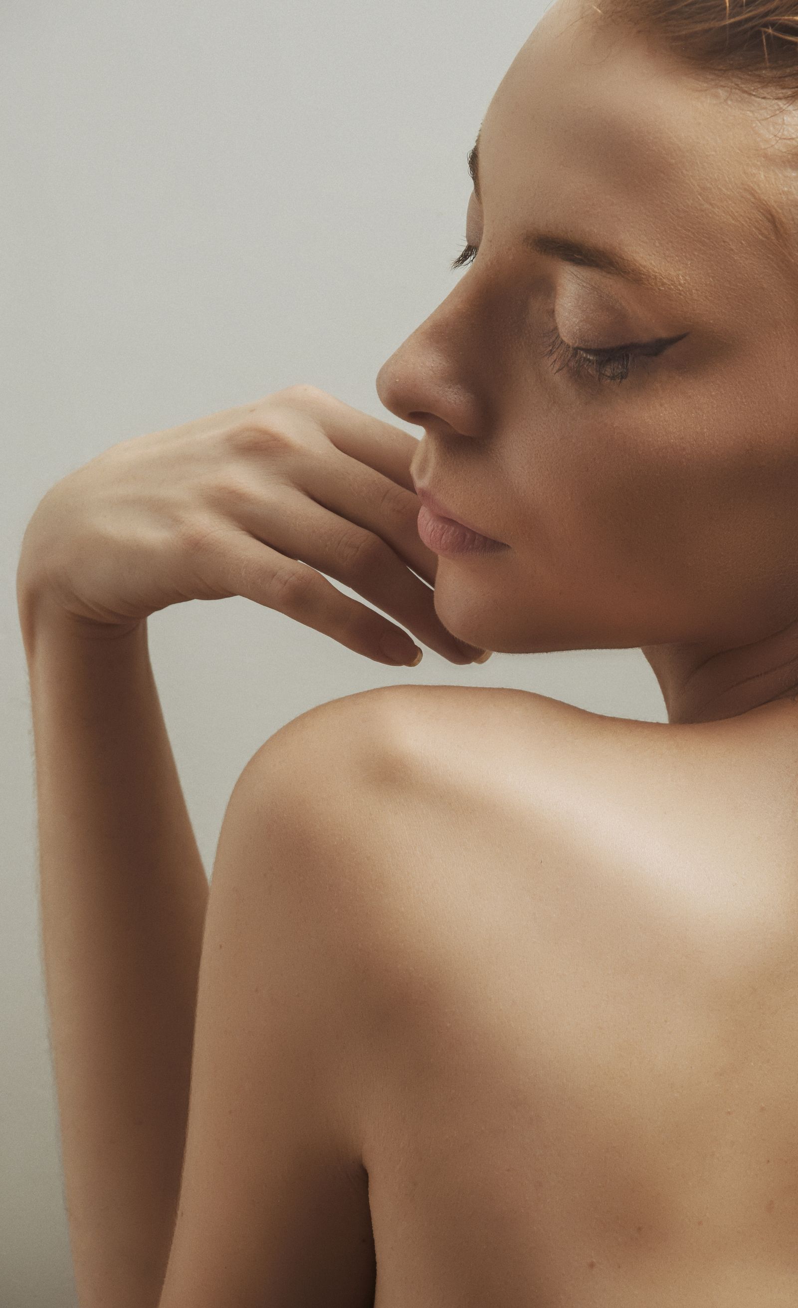 Profile of a woman with luminous, even-toned skin, eyes closed