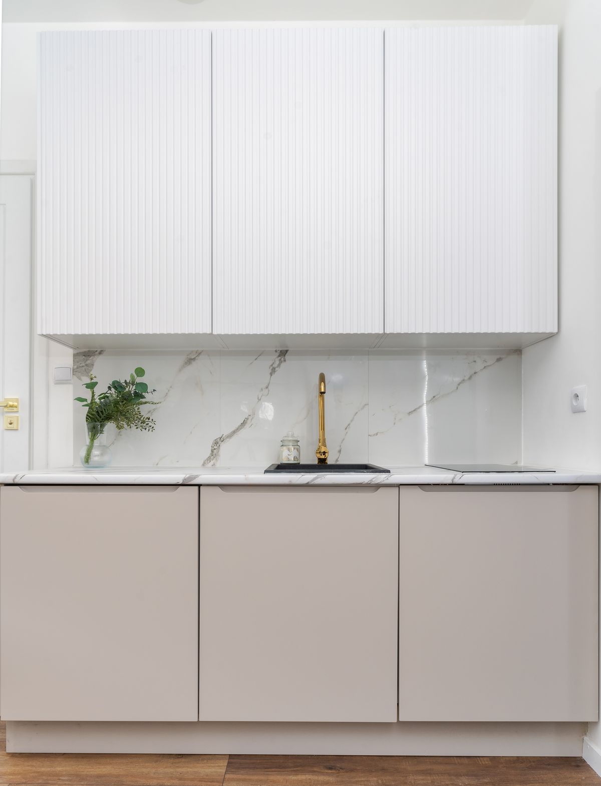 Marble backsplash and brass faucet in a Stonebrook kitchen